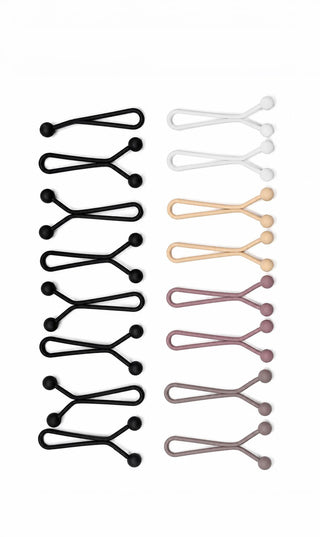 Twaalf matte hijabclips in verschillende kleuren: zwart, wit, beige, bruin en roze.