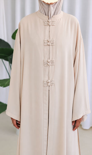 Nakaizu co-ord set, close-up crèmekleurige lange jurk met knoopsluiting en opstaande kraag